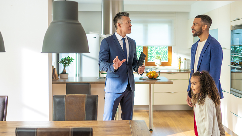 Real estate agent showing apartment to dad with daughter