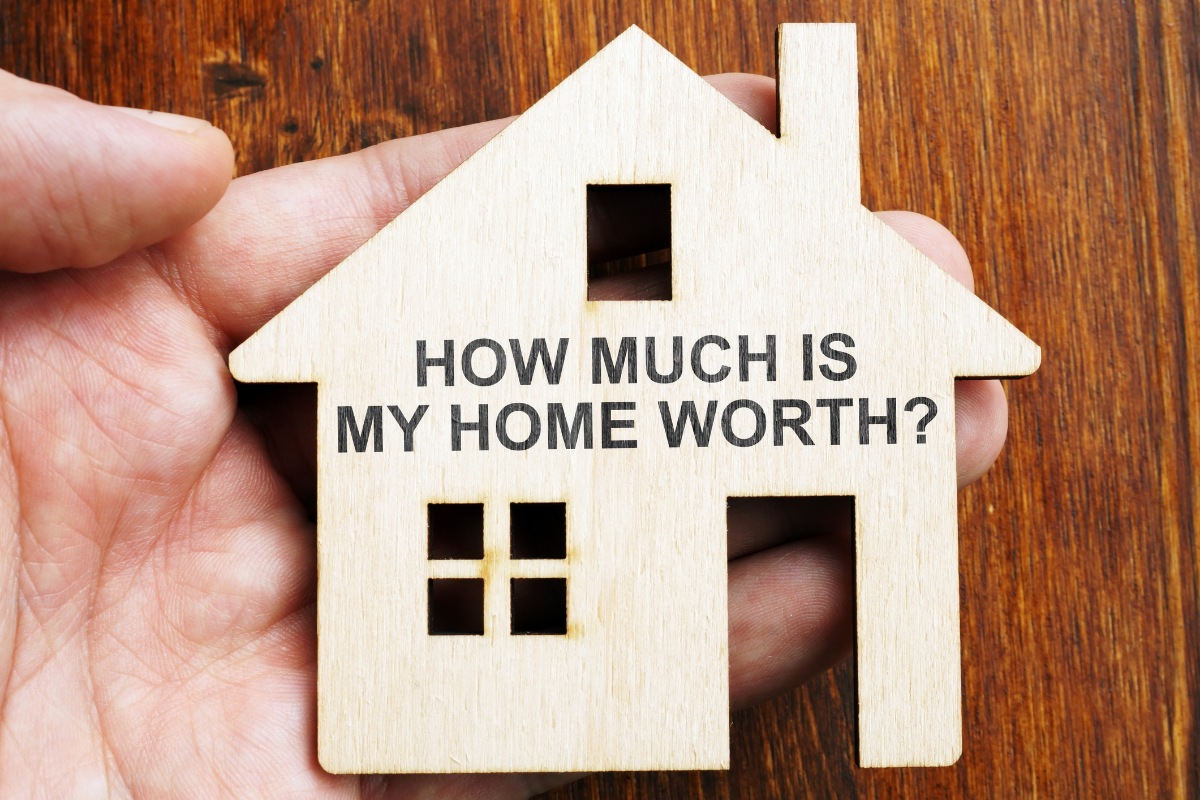 How much is my home worth? Sign on the model of house