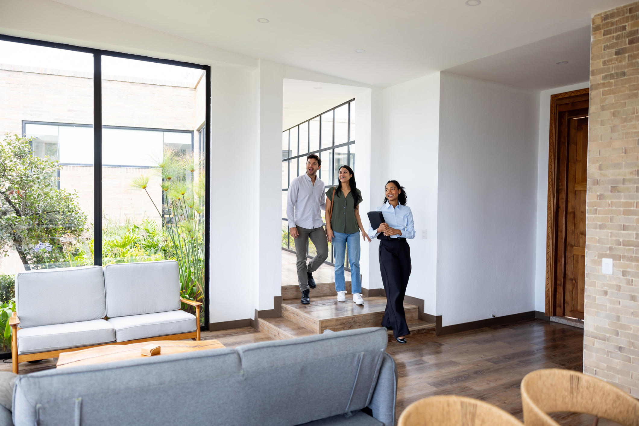 Couple looking at a house for sale with a real estate agent